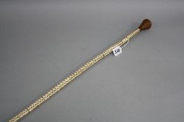 A SECTIONAL MARINE VERTEBRAE WALKING CANE, of tapering form with turned wooden handle, approximately