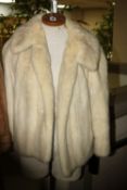 A WHITE FUR JACKET, with 'Dominion Furs' label