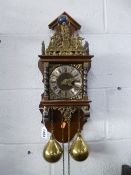 A DUTCH STYLE WALL CLOCK, with twin brass weights and pendulum