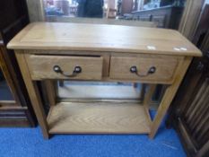 A MODERN LIGHT OAK SIDE TABLE, with two drawers and undershelf, approximate size width 85cm x