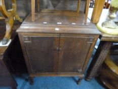 AN OAK TWO DOOR CABINET