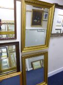 A PAIR OF MODERN RECTANGULAR GILT FRAMED MIRRORS, bevelled edge glass, 70cm x 49.5cm