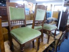 A SET OF FOUR EDWARDIAN OAK FRAMED DINING CHAIRS, with green upholstery