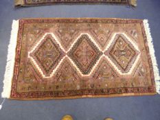 A PINK GROUND RUG, approximate size 122cm x 75cm, handmade in Iran label attached