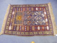 A BURGUNDY AND BLUE GROUND RUG, approximate size 120cm x 89cm