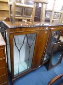 A WALNUT GLAZED TWO DOOR DISPLAY CABINET