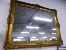 A LARGE GILT FRAMED WALL MIRROR (sd)