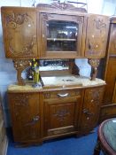 A FRENCH CARVED OAK MIRROR BACK SIDEBOARD, the glazed upper section flanked by cupboards above a