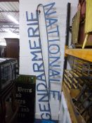 A PAINTED METAL SIGN, 'GENDARMERIE NATIONALE' (folded in half)