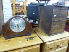AN OAK CASED MANTEL CLOCK, (key and pendulum) and a small collectors style oak chest of eight
