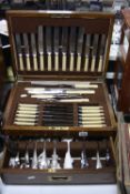 AN OAK CANTEEN OF CUTLERY, with front opening drawer (key)
