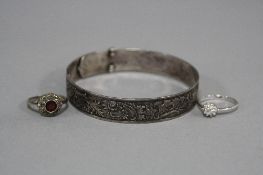 A FULLY ENGRAVED BANGLE, designed as a buckle, stamped WS Ltd Silver, a marcasite and garnet cluster