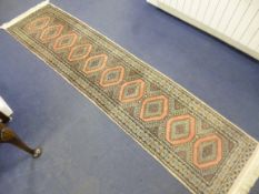A PINK GROUND CARPET RUNNER, approximate size 270cm x 64cm