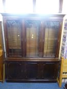 A MODERN MAHOGANY GLAZED TRIPLE DOOR BOOKCASE, with cupboard base (sd), approximate size width 153cm