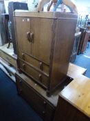 AN OAK TWO PIECE SUITE, comprising of a chest of two drawers and a tall boy with two drawers
