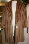 A FUR COAT, with 'Faulkes, Edgbaston' label