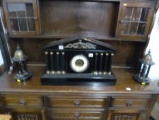 A BLACK MARBLE ARCHITECTURAL MANTEL CLOCK GARNITURE, having circular enamelled dial with Arabic