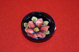 A SMALL MOORCROFT POTTERY FOOTED BOWL, Clematis design on blue ground, impressed and painted