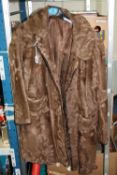 A FUR COAT, with 'Studholmes of Carlisle' label