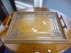 A RECTANGULAR CARVED OAK TWIN HANDLED TRAY, approximate size length 63cm x width 46cm