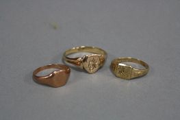 THREE GOLD SIGNET RINGS, to include a mid 20th Century shield shape head, engraved with initials '
