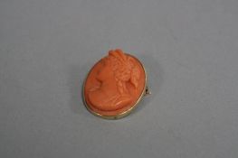 A CARVED CORAL CAMEO, of a Grecian female profile portrait, in a mount stamped 14K, length 3cm