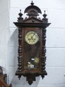 A VICTORIAN WALL CLOCK (key and pendulum)