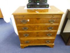 A MODERN BURR WALNUT CHEST, of four long drawers with brushing slide and bracket feet supports,