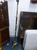 A BRASS TELESCOPIC STANDARD LAMP, with tripod base and shade