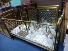 AN EARLY 20TH CENTURY BRASS COT/CHILDS BED, with drop down sides and mattress