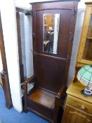 A SLIM OAK HALL STAND, with lift up seat