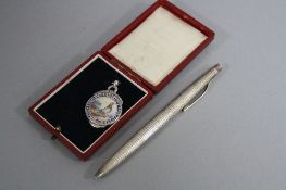A SILVER AND ENAMEL FOB 'National Union of Short Distance Flyers' and a silver pen (2)