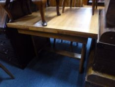 AN OAK DRAW LEAF DINING TABLE