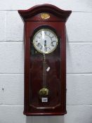 A MODERN WALL CLOCK, marked 'London Clock Co', (key and pendulum)