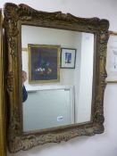 A GILT FRAMED WALL MIRROR, approximate size 70cm x 57cm