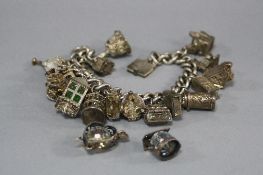 A SILVER CHARM BRACELET, with various charms