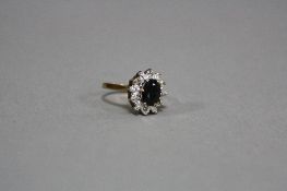 A LATE 20TH CENTURY 9CT GOLD SAPPHIRE AND DIAMOND CLUSTER RING, sapphire measuring approximately 8mm