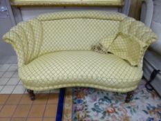 A VICTORIAN CURVED TWO SEATER SOFA, with lemon patterned upholstery