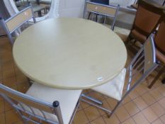 A METAL FRAMED CIRCULAR TABLE AND FOUR CHAIRS, (situated in cafe area)