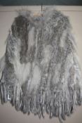 A GREY RABBIT FUR PONCHO WITH HOOD