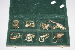 A BOX OF EIGHT NOVELTY KEY RINGS