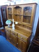 A PINE GLAZED DRESSER, with three small drawers, approximate size width 124cm x height 177cm x depth