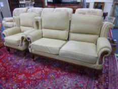 A BEIGE UPHOLSTERED TWO PIECE SUITE, with carved wood detail, comprising two seater sofa and a