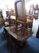 A CARVED OAK DINING SUITE, comprising of a draw-leaf table, approximate size extended length 223cm x