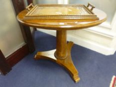 A WALNUT OVAL CENTRE TABLE, on pillar support and tri-form base, approximate size length 90cm x