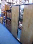 A FIVE PIECE STAG TEAK BEDROOM SUITE, comprising a wardrobe, dressing table with mirror, chest of