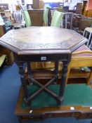 A CARVED OAK OCCASIONAL TABLE, with octagonal top, spiral tapering supports and cross stretcher