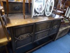 A LARGE OAK SIDEBOARD, with raised back, drawers and cupboards, on bobbin turned front supports (