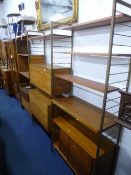 A 'STAPLES LADDEREX' STACKING TEAK SHELVING UNIT, comprising various open shelves, cupboards and