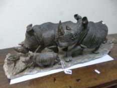 A CARVED HARDSTONE 'RHINOSCEROUS FAMILY', figure on base
